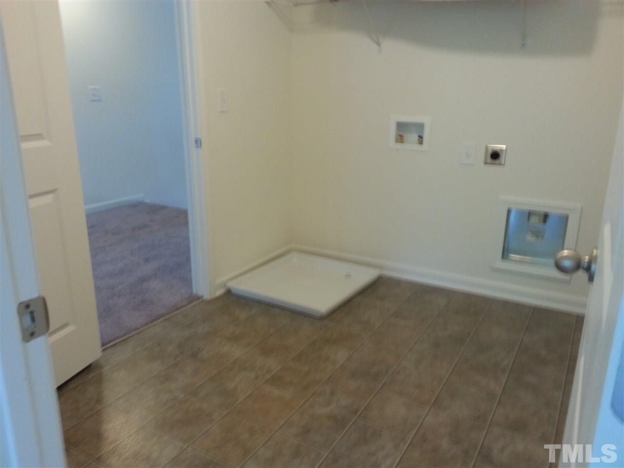 7516 Channery Way Raleigh, NC 27616 - Photo 12 of 25 an empty room with a door
