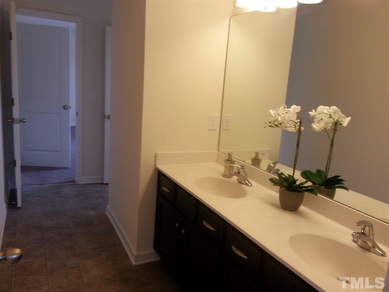 7516 Channery Way Raleigh, NC 27616 - Photo 15 of 25 a bathroom with a double vanity sink and a mirror