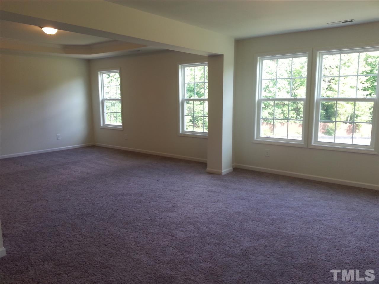 7516 Channery Way Raleigh, NC 27616 - Photo 18 of 25 a view of an empty room with windows