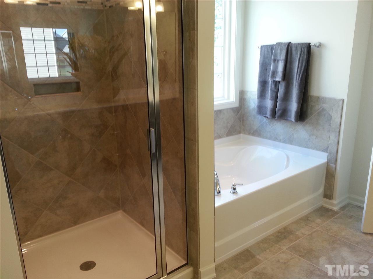 7516 Channery Way Raleigh, NC 27616 - Photo 22 of 25 a bathroom with a tub and shower