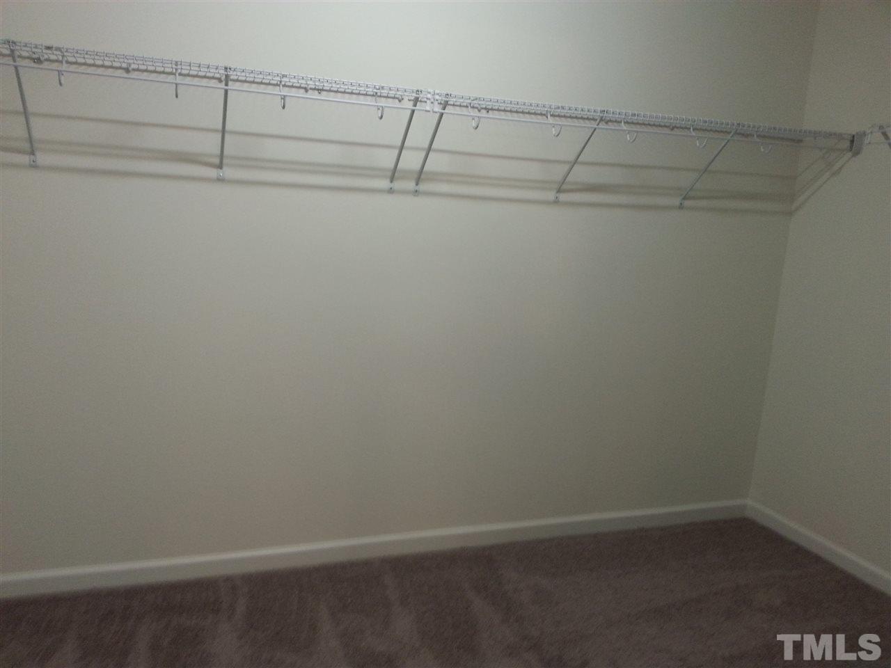 7516 Channery Way Raleigh, NC 27616 - Photo 23 of 25 a view of a room with racks on the wall