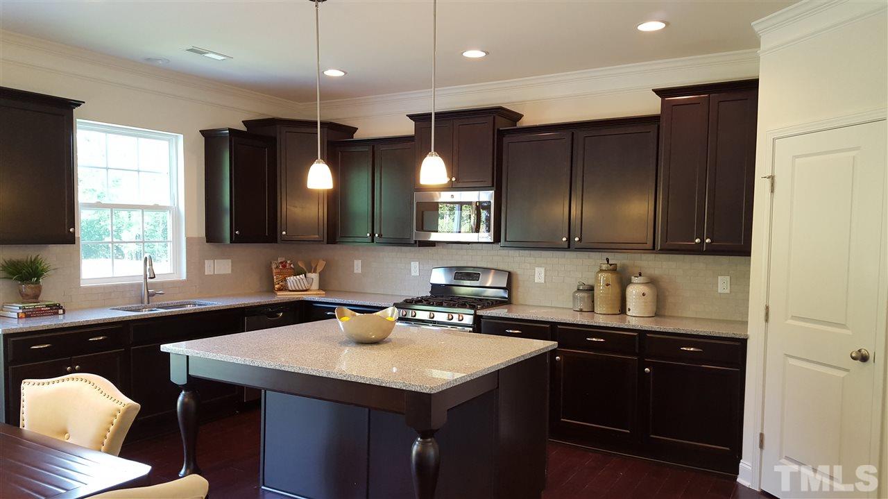 7516 Channery Way Raleigh, NC 27616 - Photo 4 of 25 a kitchen with a sink cabinets and window