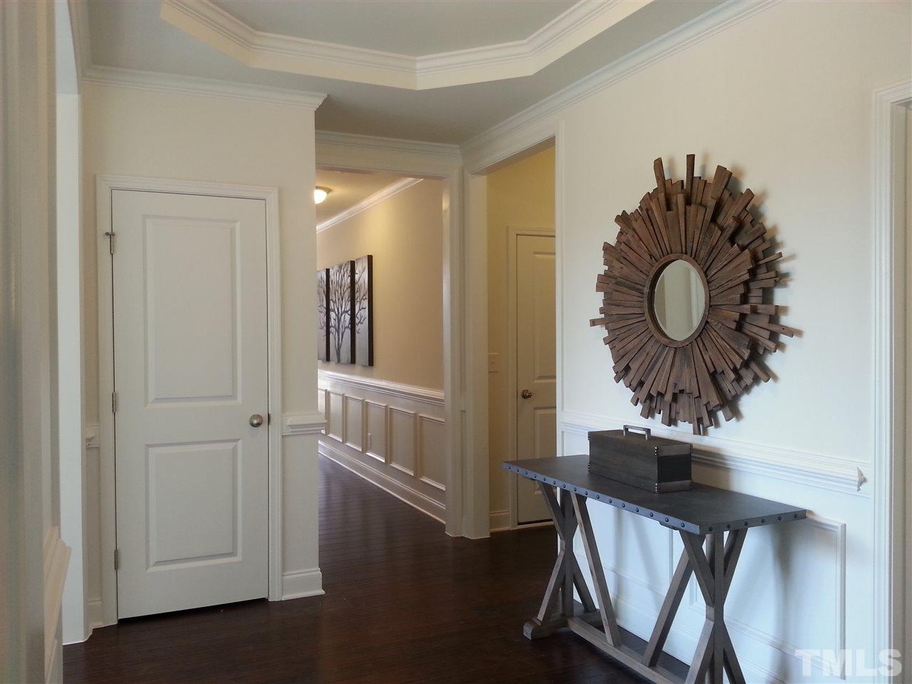7516 Channery Way Raleigh, NC 27616 - Photo 7 of 25 a view of entryway with livingroom and wooden floor