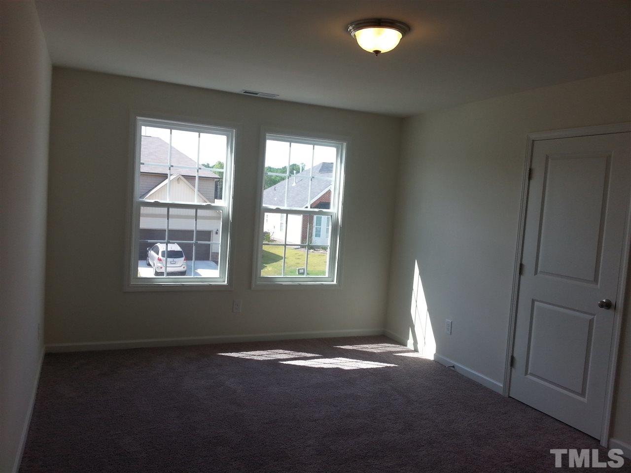 7516 Channery Way Raleigh, NC 27616 - Photo 9 of 25 a view of empty room with windows