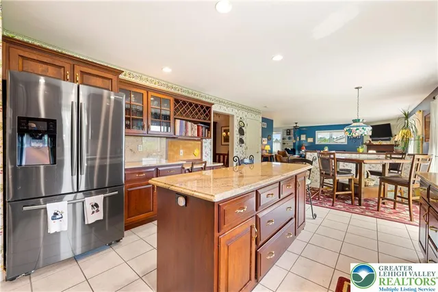 a kitchen with stainless steel appliances granite countertop a stove a sink dishwasher and cabinets with wooden floor