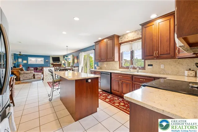 a kitchen with granite countertop cabinets sink and window