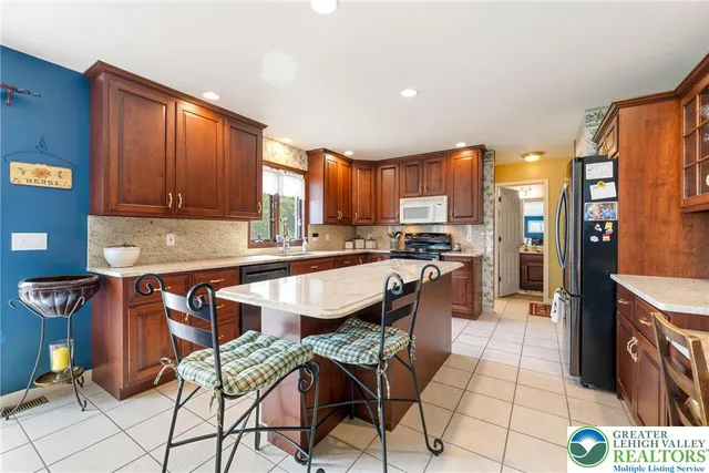 a kitchen with stainless steel appliances granite countertop a sink and cabinets