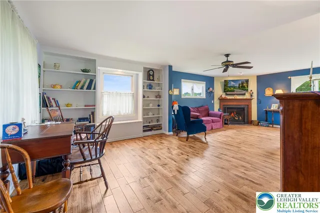 a dining room with furniture and wooden floor