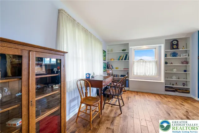 a view of a dining room with furniture a chandelier and wooden floor