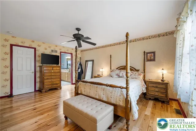 a bedroom with a bed and a large window