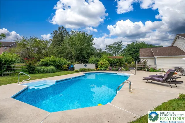a view of a swimming pool with lounge chair