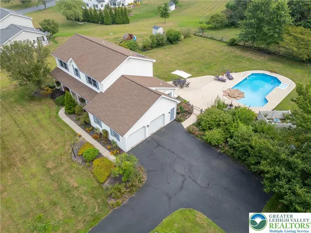 an aerial view of residential houses with outdoor space