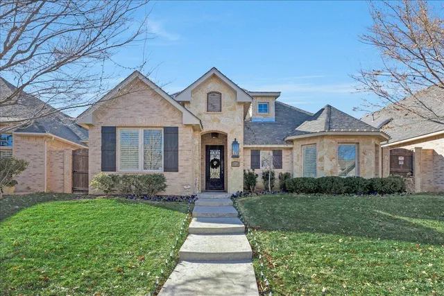 a front view of a house with yard and green space