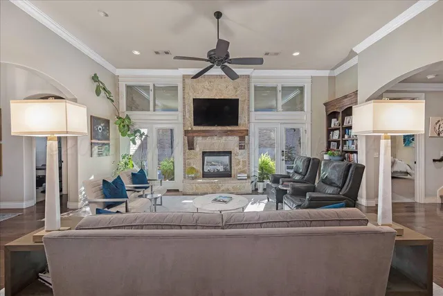 a living room with furniture a flat screen tv and a fireplace