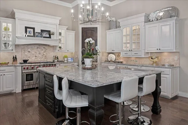a kitchen with granite countertop a sink and stove