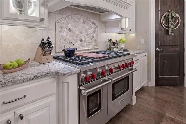 a stove top oven sitting inside of a kitchen