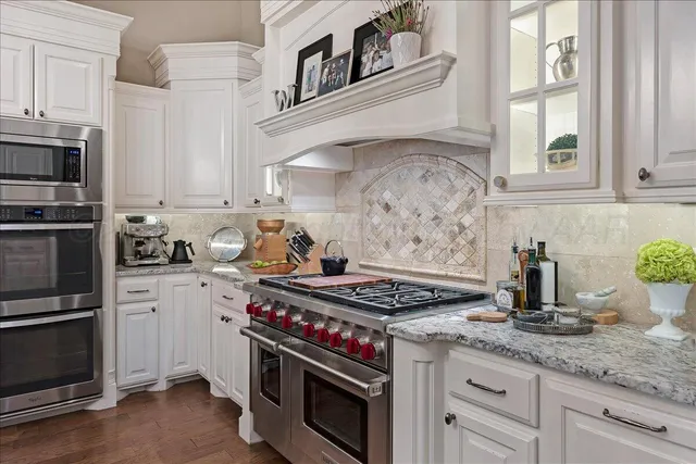 a kitchen with granite countertop a stove and a sink