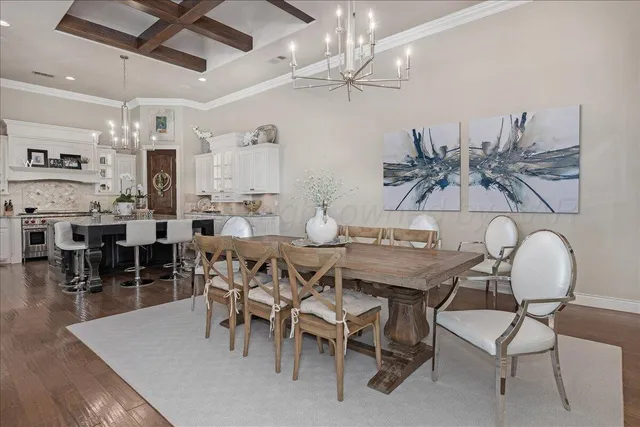 a view of a dining room with furniture and chandelier