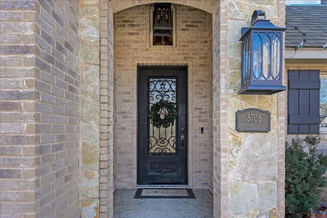 a front view of a house with white wall and door