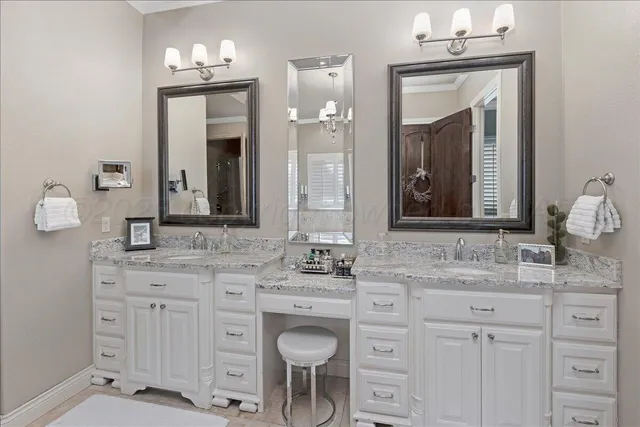 a bathroom with a sink vanity and mirror