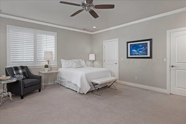 a spacious bedroom with a bed and couch