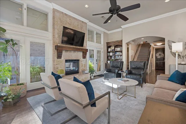 a living room with furniture a fireplace and a flat screen tv
