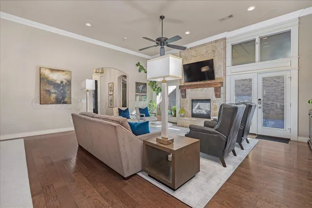 a living room with fireplace furniture and a flat screen tv