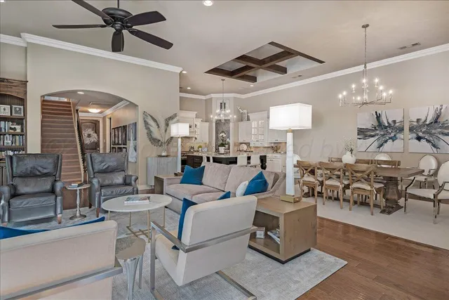 a living room with lots of furniture and view of a chandelier