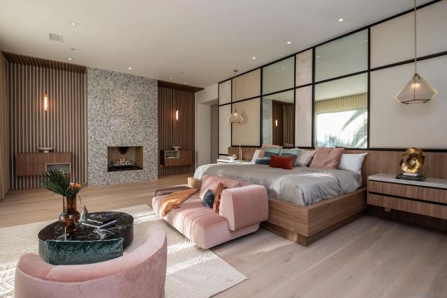 a bedroom with a bed and a flat tv screen on the dresser