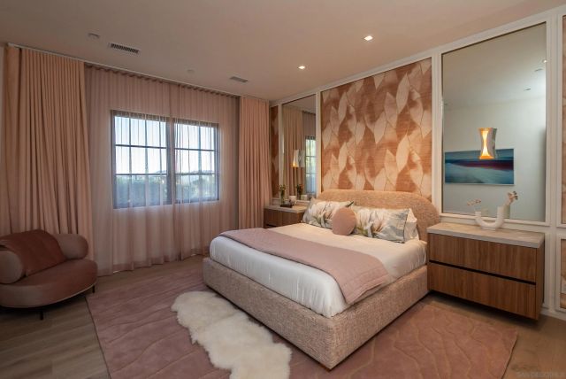 a living room with furniture floor to ceiling windows and a table