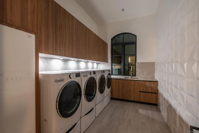 a view of a tennis ground with large trees