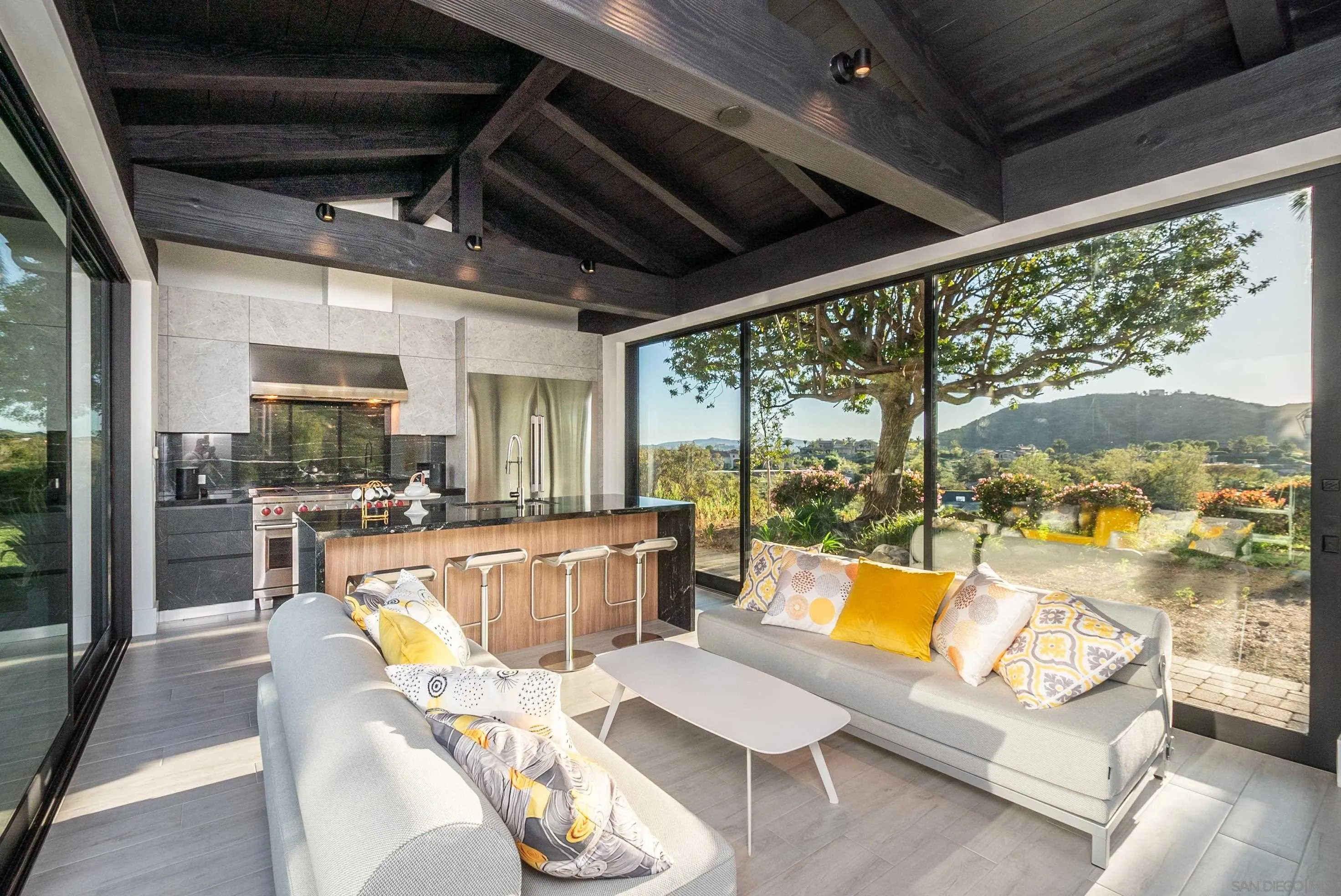 18650 Old Coach Way Poway, CA 92064 - Photo 50 of 63 a living room with furniture floor to ceiling windows and a table
