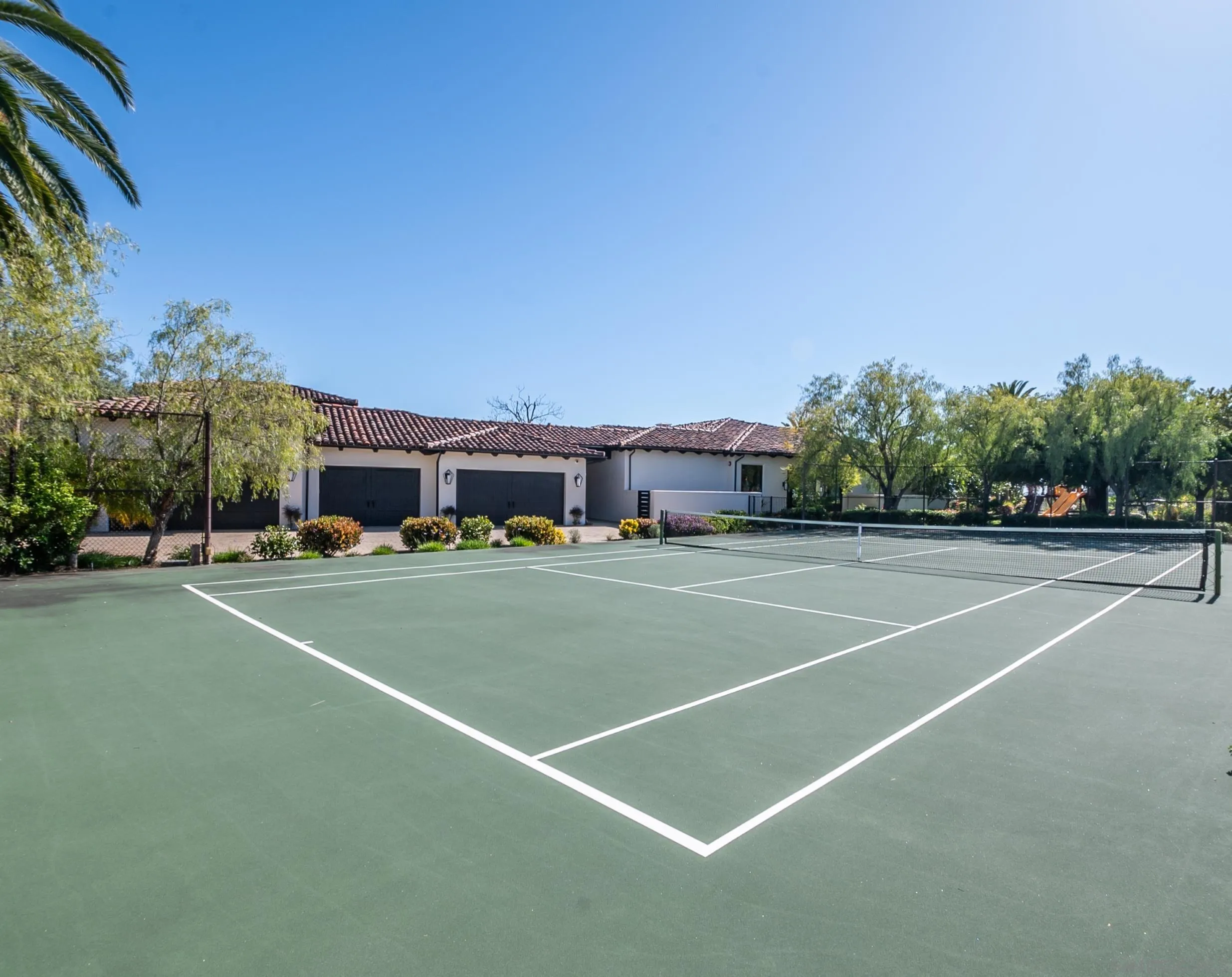 18650 Old Coach Way Poway, CA 92064 - Photo 57 of 63 a view of a tennis ground with large trees