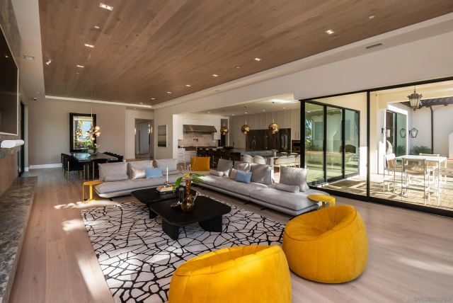 a living room with fireplace furniture and a large window