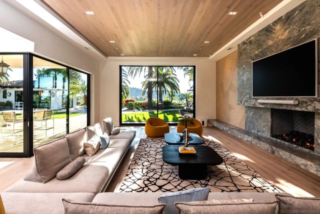 a living room with fireplace furniture and a flat screen tv