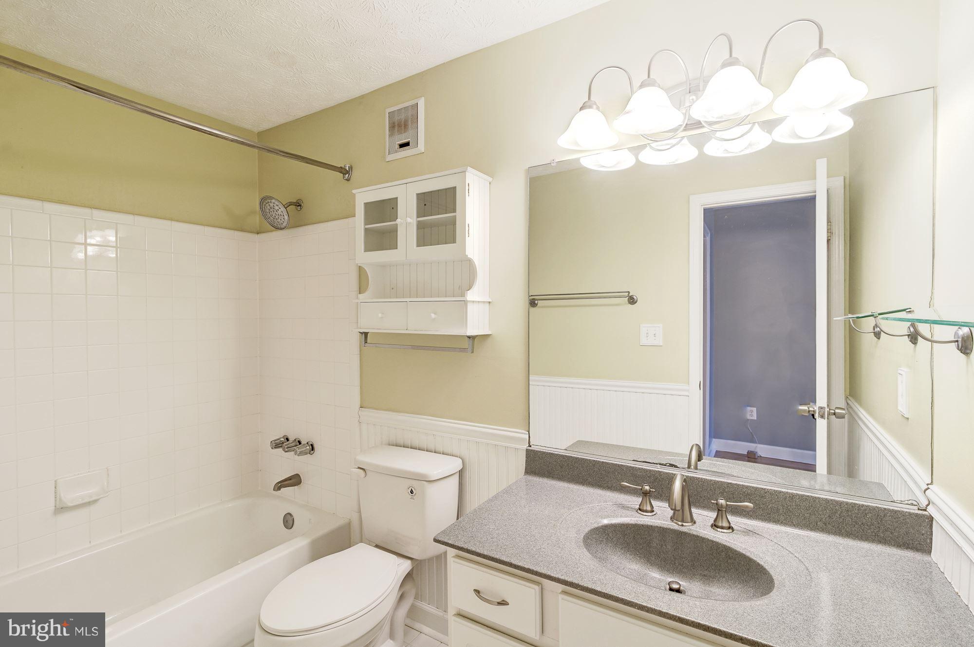 2224 Hunter's Run Drive, Unit 2224 Reston, VA 20191 - Photo 17 of 21 a bathroom with a sink a toilet and shower