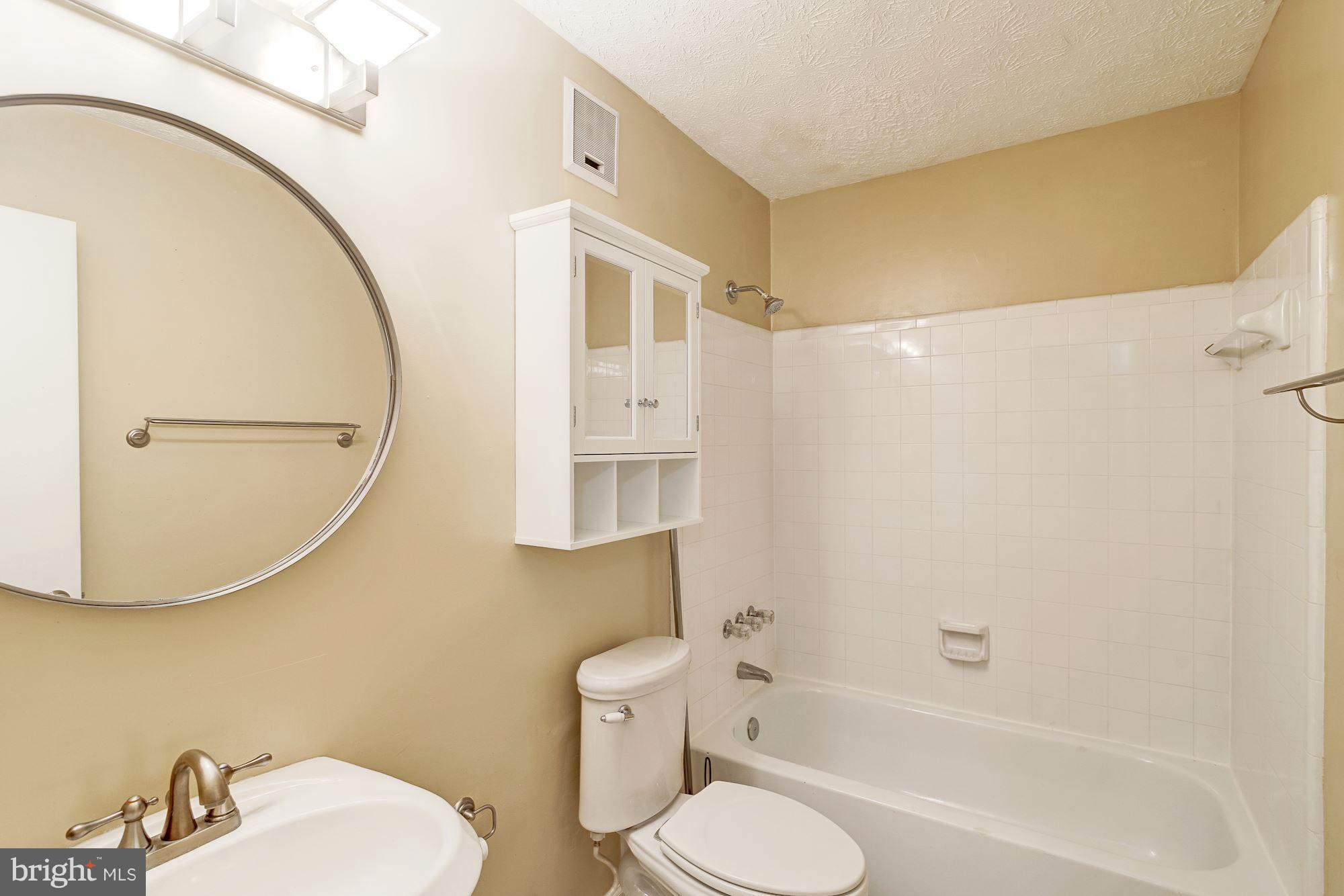 2224 Hunter's Run Drive, Unit 2224 Reston, VA 20191 - Photo 20 of 21 a bathroom with a sink toilet and shower