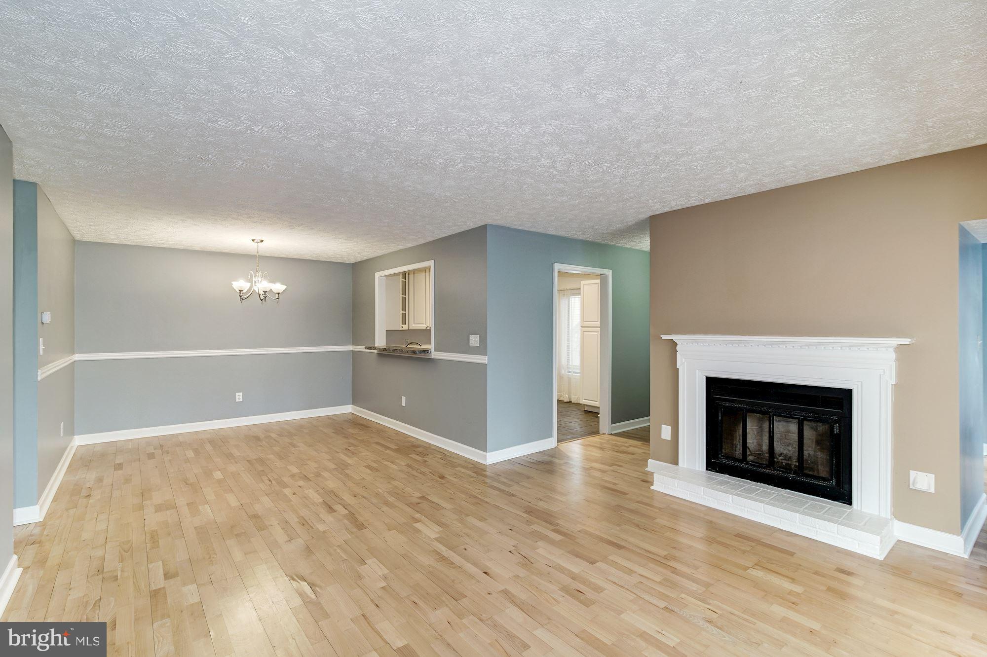 2224 Hunter's Run Drive, Unit 2224 Reston, VA 20191 - Photo 3 of 21 a view of an empty room with a fireplace and a window
