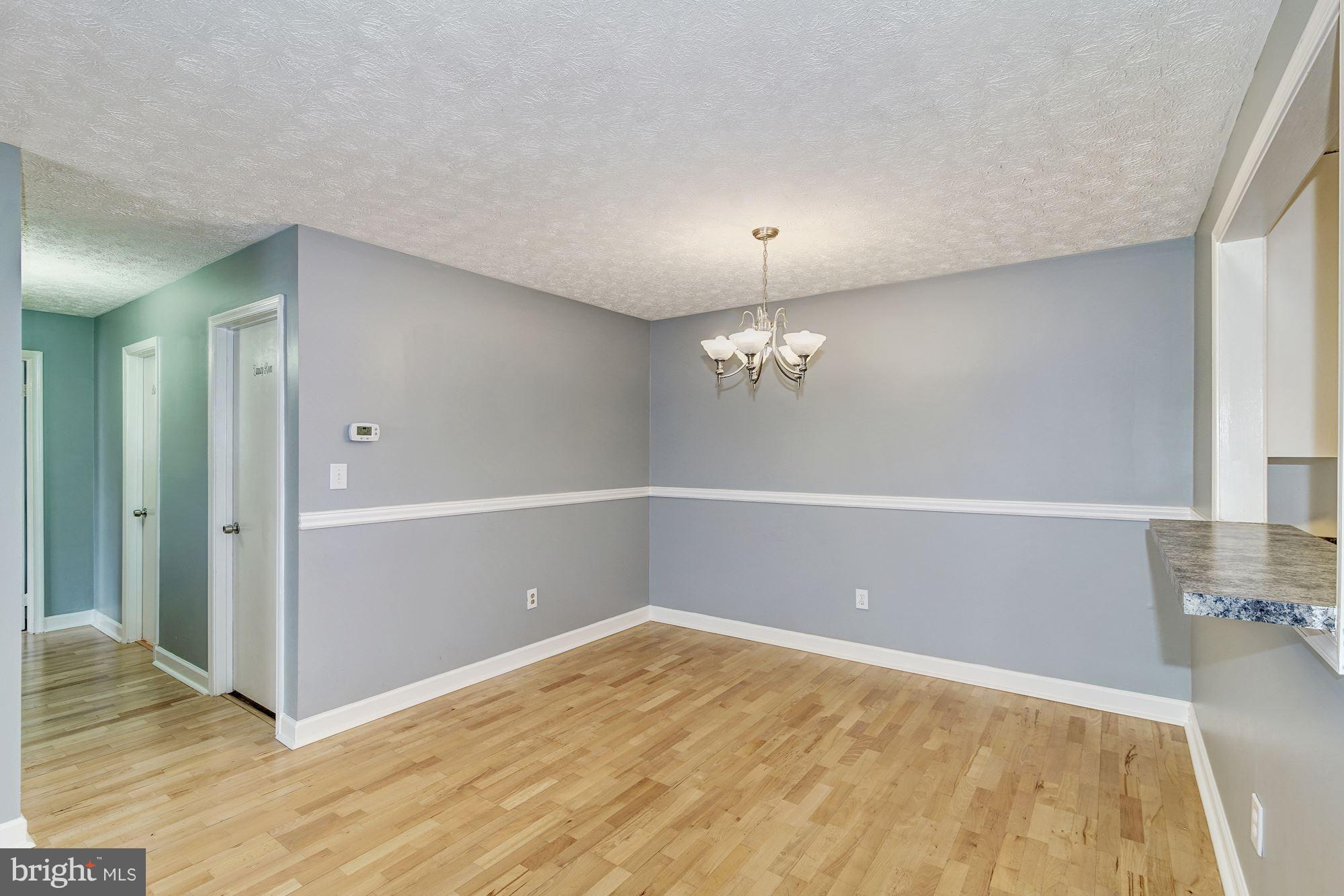2224 Hunter's Run Drive, Unit 2224 Reston, VA 20191 - Photo 7 of 21 wooden floor in an empty room with a window