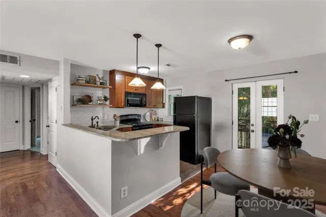 a kitchen with stainless steel appliances granite countertop a sink a stove and refrigerator