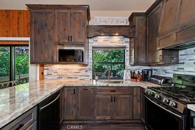 a kitchen with stainless steel appliances wooden cabinets and a stove top oven