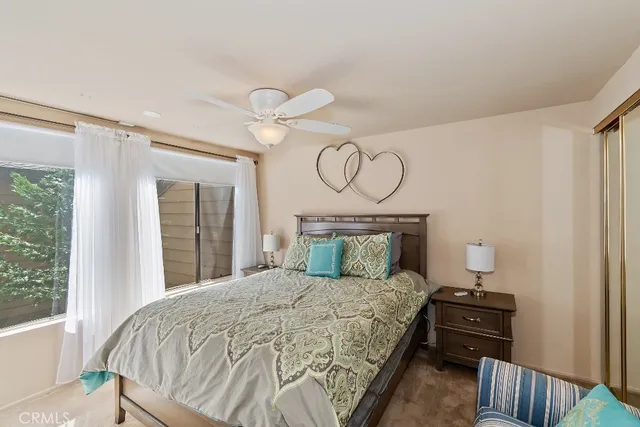 a bed sitting in a bedroom next to a window