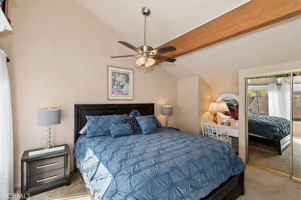 a bedroom with a bed and a ceiling fan