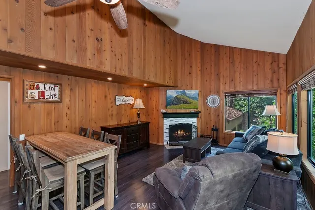 a living room with furniture a fireplace and a window