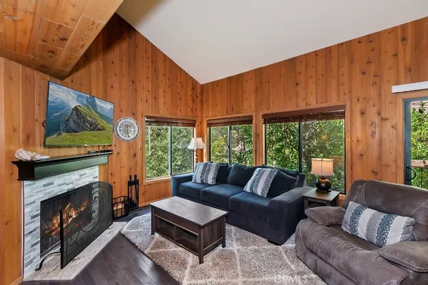 a living room with furniture a fireplace and a window