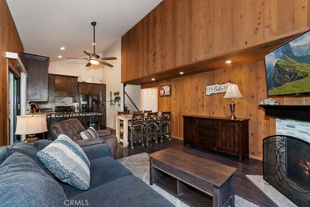a living room with furniture a fireplace and kitchen view