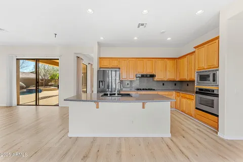 a view of a kitchen with microwave and furniture