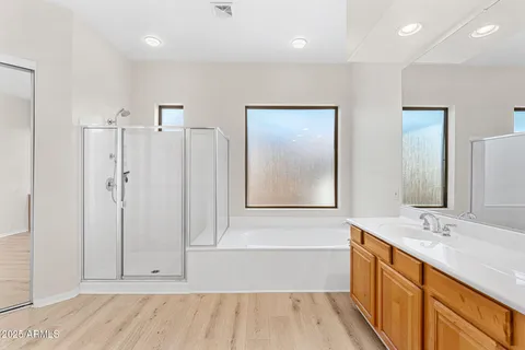 a kitchen with stainless steel appliances granite countertop white cabinets and a window