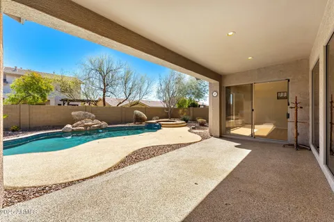 a large kitchen with stainless steel appliances a large counter top and a wooden floors