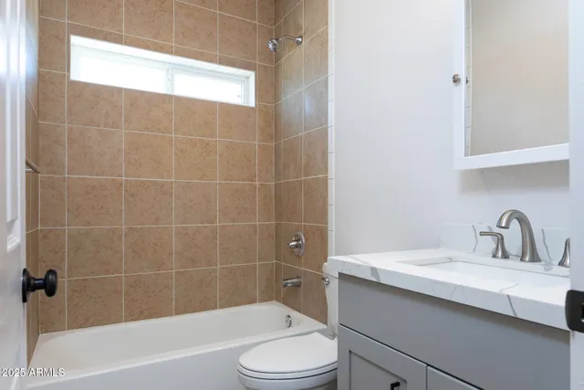 a bathroom with a sink a toilet and bathtub